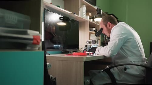 Scientist Using Microscope in Modern Laboratory Setting