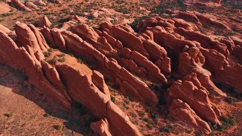 Footage over the ridged thin canyons in the dry desert. Landscape of the Arches national Park