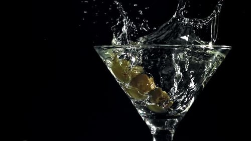 Olives Dropping into Martini Glass in Slow Motion