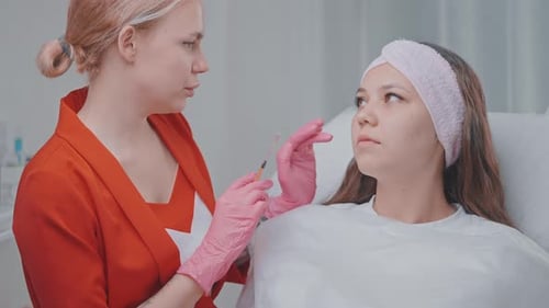 Cosmetologist Prepares Young Woman to Beauty Injections in Cosmetology Clinic