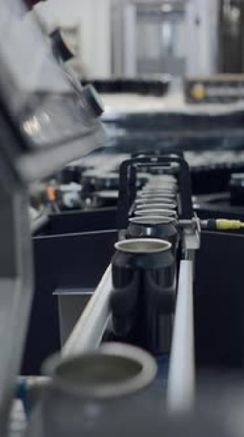 Empty Aluminum Beer Cans Moving Along The Conveyor Belt Close Up