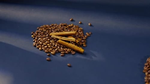 Coffee Beans and Cinnamon Sticks on Surface