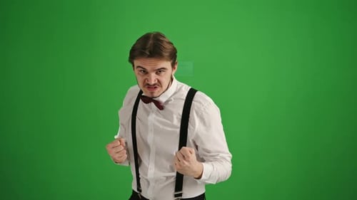 Young Man in Fighting Stance on Green Background