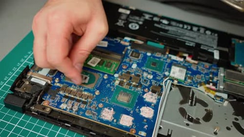 Cleaning Old Thermal Paste From Processor Chip in Laptop Motherboard Removing Dried Compound From