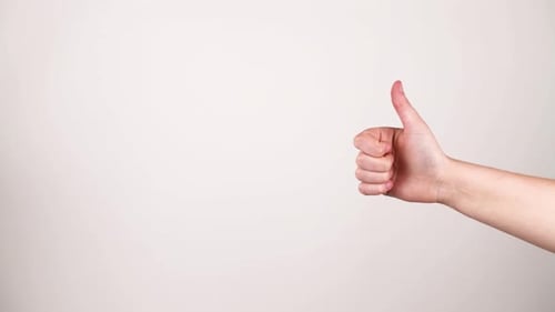 Two thumbs up and down one on either side coming in and out of frame.