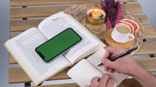 man writing green screen phone
