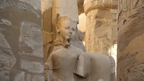 Egyptian Statue of a Pharaoh Near Columns in a Ruined Temple