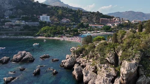 A stunning coastal town with rocky shores and clear blue waters, aerial view