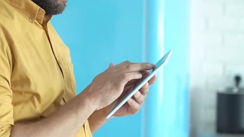 Man uses touch screen tablet in a home