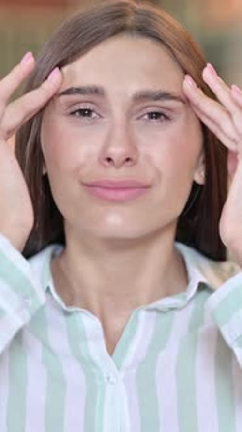 Woman Massaging Temples with Headache in Vertical Video