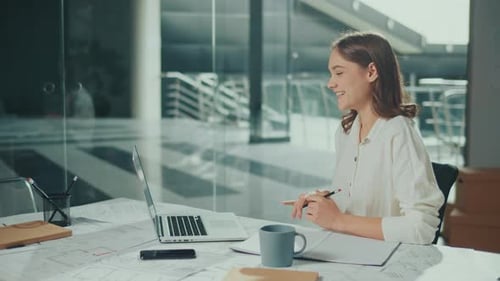Female Architect Working in a Office at a Laptop Making a Video Call