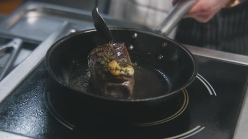 Male Cook Pours Beef Meat with Oil