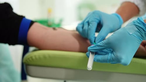 Closeup of Unrecognizable Female Lab Assistant Wearing Medical Gloves Taking Venous Blood From Arm