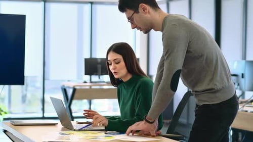 Coworkers Collaborating on Project in Modern Office