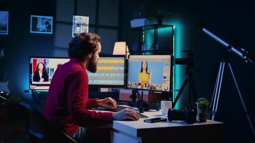Man Working at Computer in Modern, Teal Lit Room