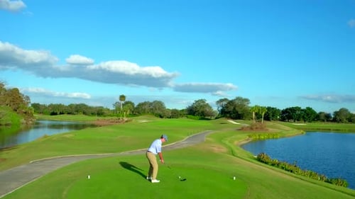 Golfer Swinging Driver on Beautiful Golf Course Aerial