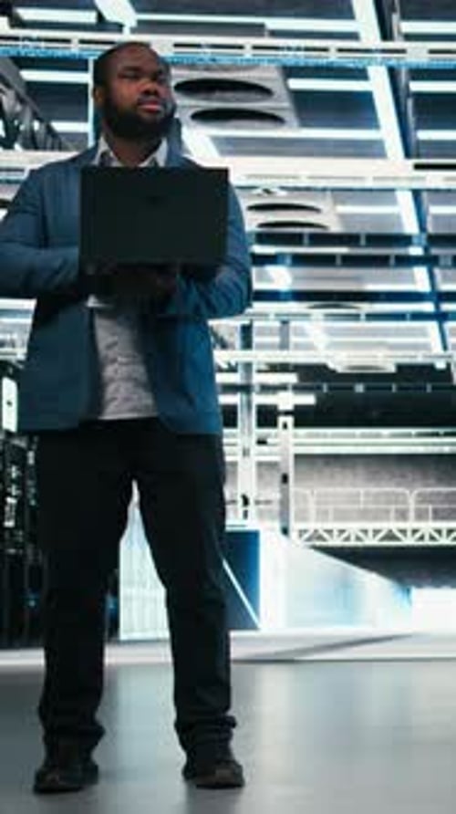 Vertical Video Team of Server Farm Software Developers Using Laptop to Optimize Electronics