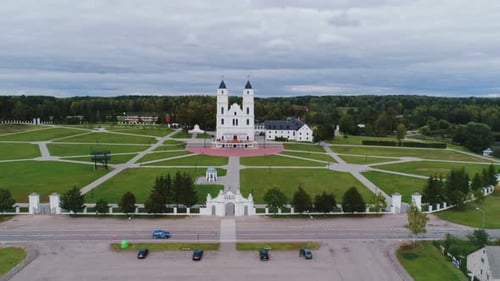 Drone Aerial View of Aglona Basilica Latvia With Road and Blue Car in Foreground