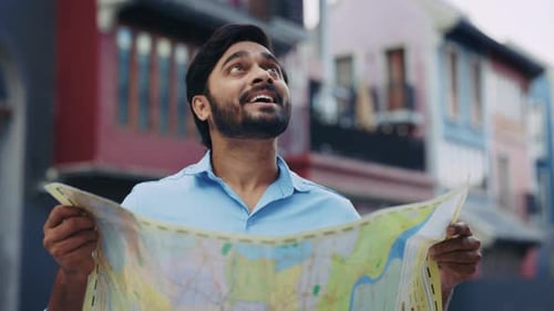 Young Adult Man Reads City Map on Street