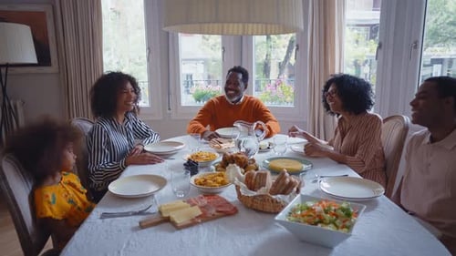 Smiling Family Enjoying Meal Together at Home