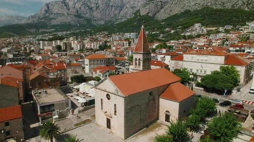Historic Town Square by Ancient Church Steeple. Old town with architectural heritage amidst mountain