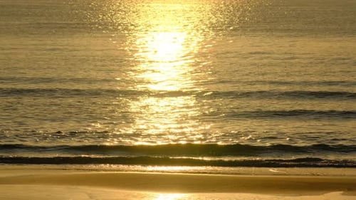 Wave splashing in sunrise or sunset on a tropical beach.