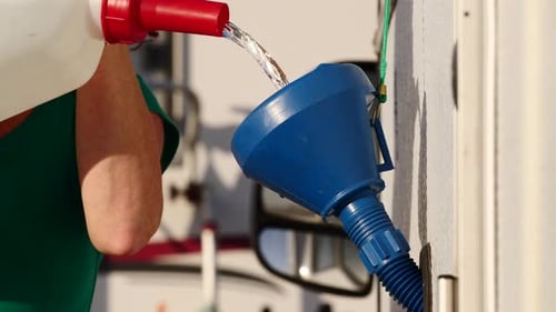 Liquid Poured into a Blue Plastic Funnel