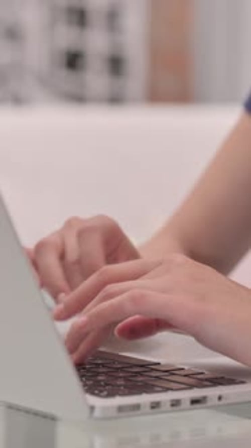 Close Up of Female Hands Typing on Laptop, vertical