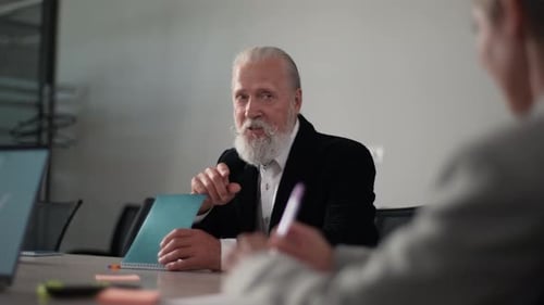 Senior Man Speaking During a Business Meeting