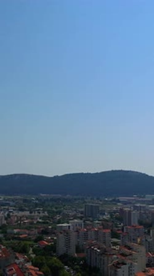 Resort cityscape at the shore of Adriatic Sea. Mountain range surrounding the city. Top view.