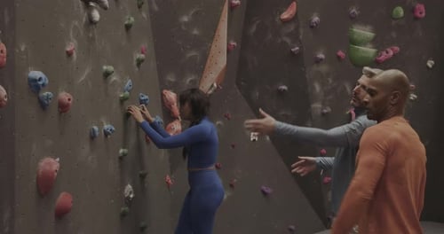 Adults Rock Climbing at an Indoor Gym