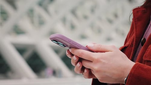 Woman Using Smartphone in Urban Setting