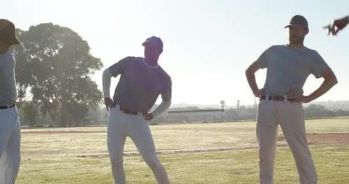 Starting warm-up diverse baseball teammates doing stretches on grassy field, with caps and cleats
