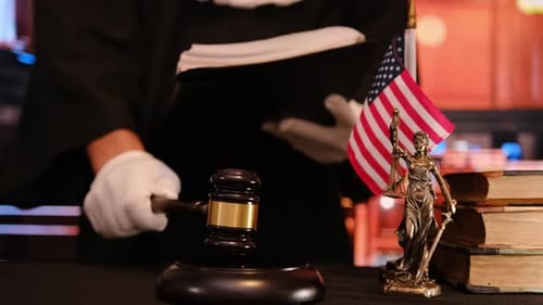 Judge Holding Document with USA Flag and Gavel