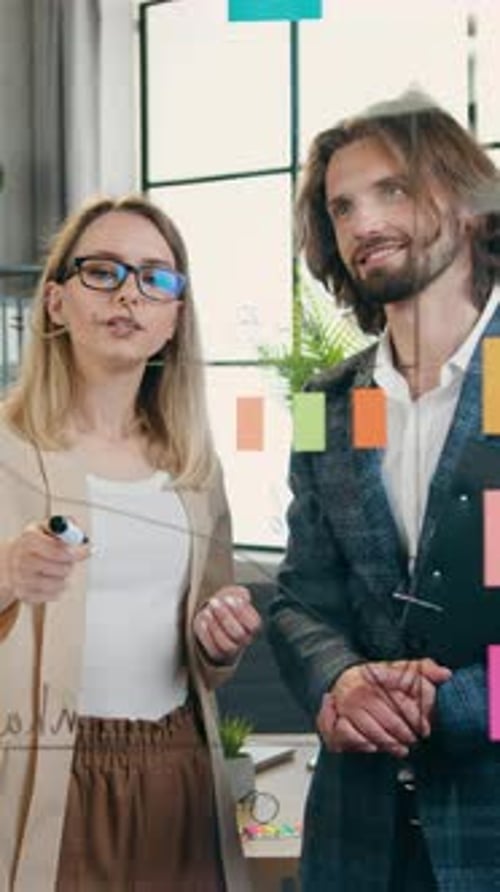 Close Up of Likable Positive Creative Professional Teammates Man and Woman Which Standing Near Glass