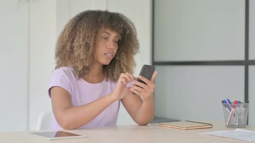 Woman Reacts with Shock While Using Mobile Phone