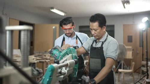 Carpenters are working together at workshop.