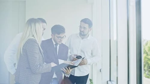 Business Team Discussing Documents in a Modern Office