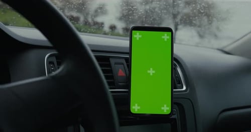 Empty Green Screen of Smartphone in a Car