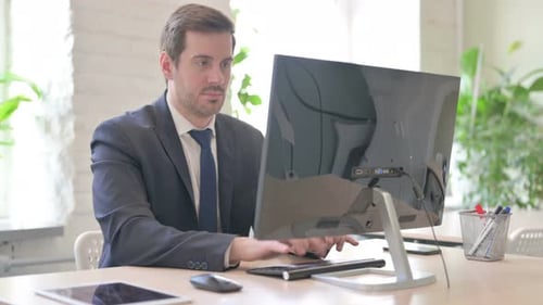 Man Working at Desk in Modern Office