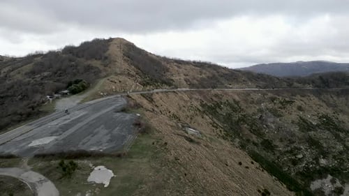 Motorcycles Traveling Winding Road Aerial View