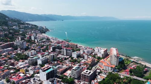 Dron flying over the vibrant city of Puerto Vallarta, Mexico, with the Pacific Ocean in the backgrou