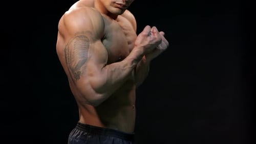 Close Up Black Athletic Man Shows Biceps