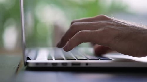 Hands typining on laptop. Closeup hand types on computer keyboard with depth of field