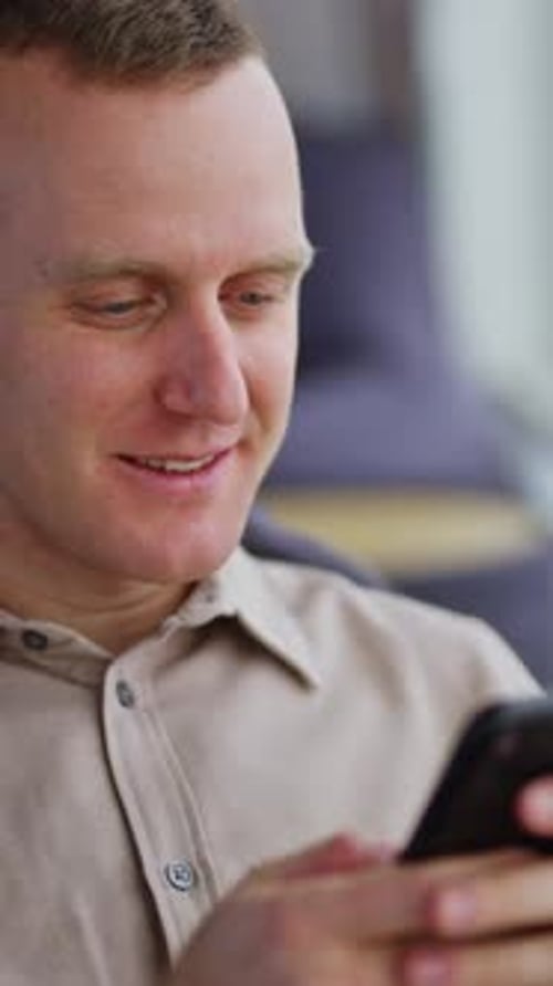 Young Adult Using a Smartphone Indoors