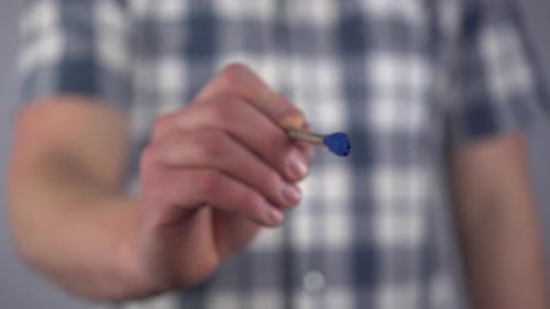 A Young Man Draws a Mathematical Minus Sign on the Glass