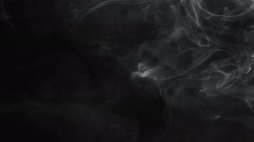 White Smoke Billowing Against Black Background