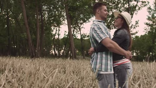 Romantic and In-Love Couple Holding Each Other in Grass Field