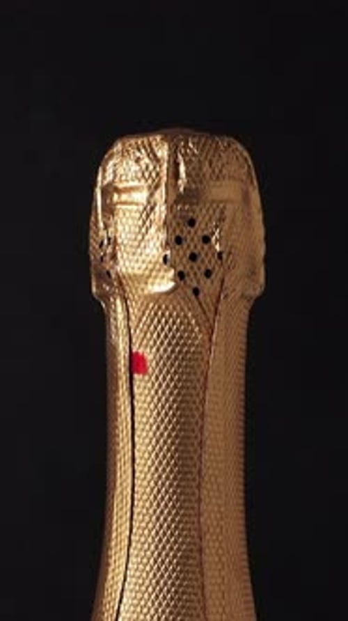 Champagne Bottle Rotating on Black Background New Year Celebration Vertical