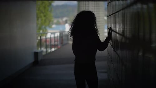 Happy Young Woman with Curly Hair Dancing on City Street in Slow Motion